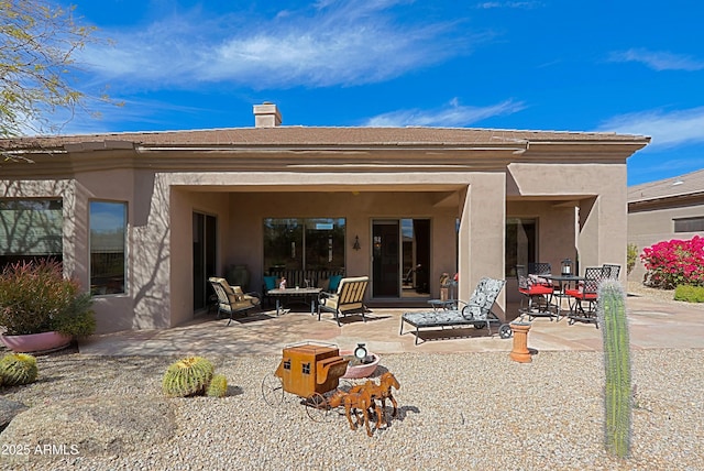 back of house featuring a patio area and stucco siding