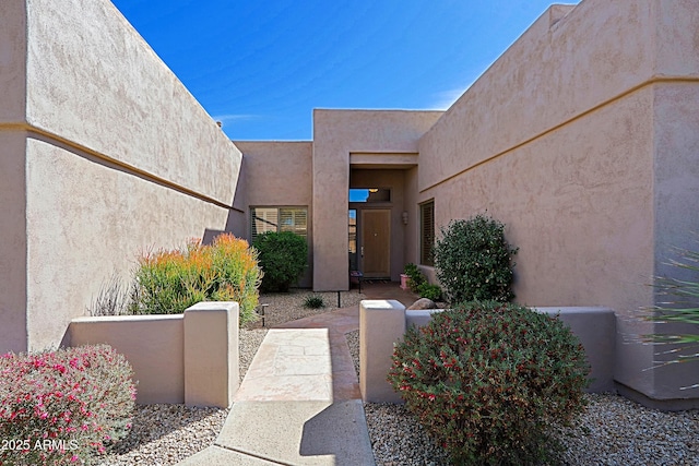 doorway to property with stucco siding