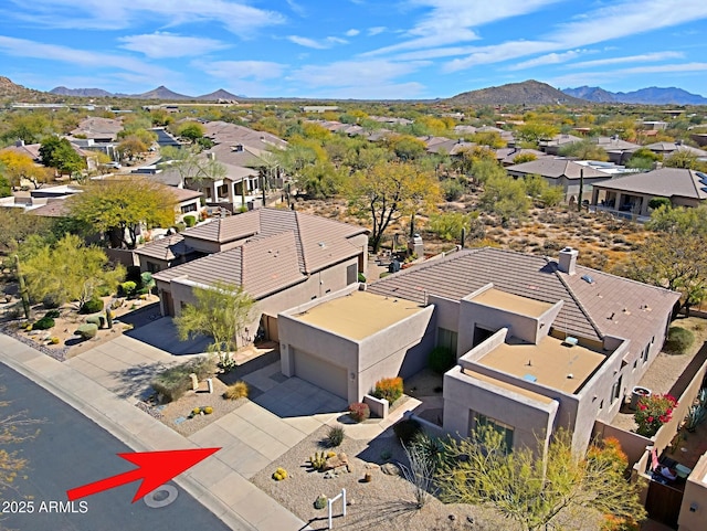 drone / aerial view featuring a residential view and a mountain view