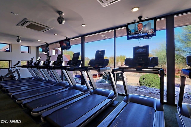 exercise room featuring a wall of windows and recessed lighting