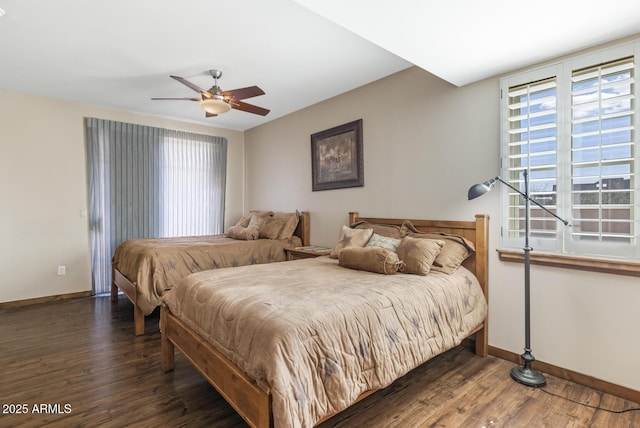 bedroom with ceiling fan, baseboards, and wood finished floors