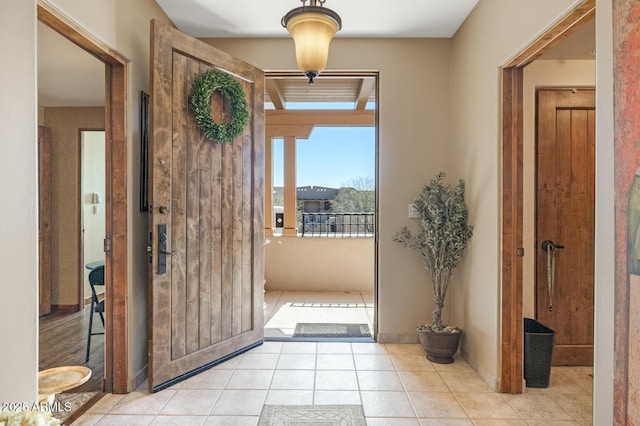 entryway featuring light tile patterned floors and baseboards