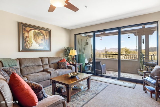 carpeted living area with ceiling fan