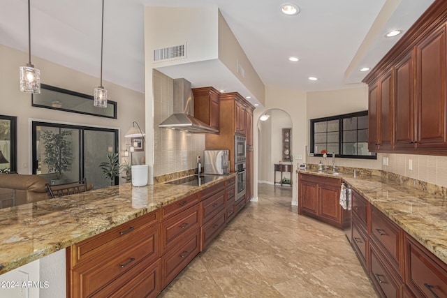 kitchen featuring light stone counters, hanging light fixtures, wall chimney exhaust hood, decorative backsplash, and black electric cooktop