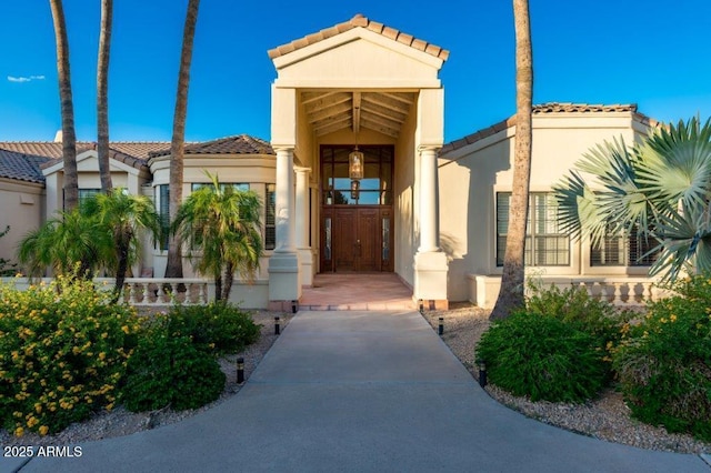 view of exterior entry with stucco siding