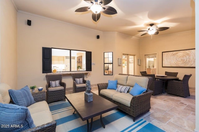 interior space featuring ornamental molding, stone finish floor, plenty of natural light, and a ceiling fan