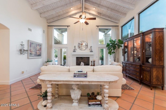 living room with light tile patterned floors, high vaulted ceiling, and wood ceiling