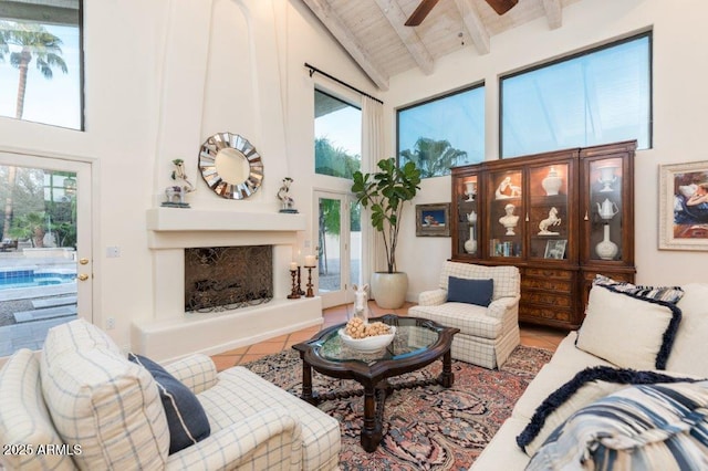 living room with high vaulted ceiling, a fireplace, wooden ceiling, and tile patterned floors