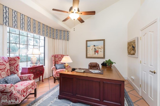 office area featuring lofted ceiling, ceiling fan, and light tile patterned flooring