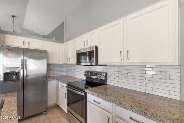 kitchen featuring light stone countertops, white cabinetry, lofted ceiling, and stainless steel appliances