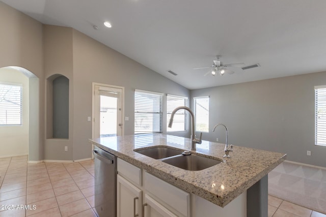 kitchen featuring dishwasher, white cabinetry, sink, a kitchen island with sink, and light tile patterned floors