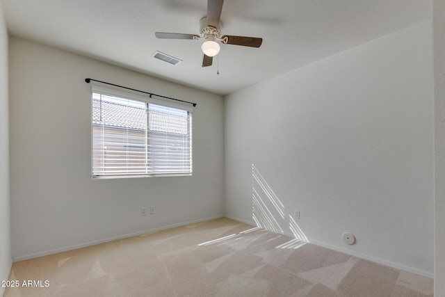 empty room with light colored carpet and ceiling fan