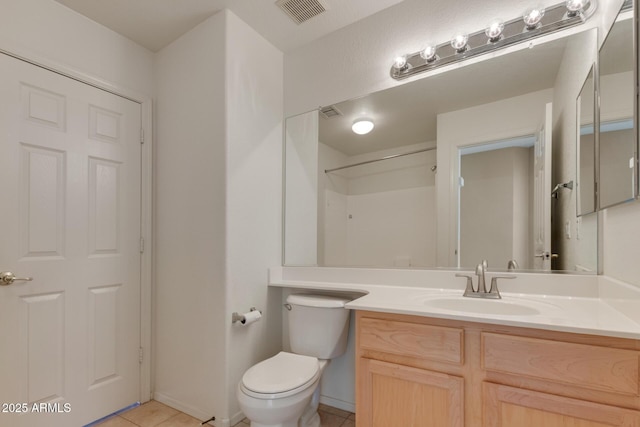 bathroom with toilet, tile patterned floors, a shower, and vanity