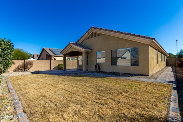 rear view of house with a lawn