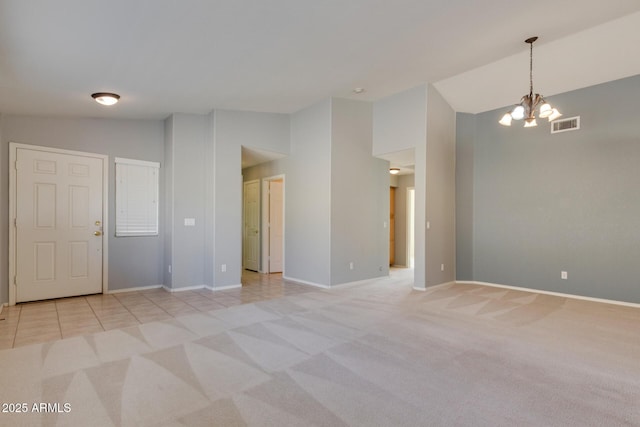 unfurnished room with a notable chandelier, light colored carpet, and lofted ceiling