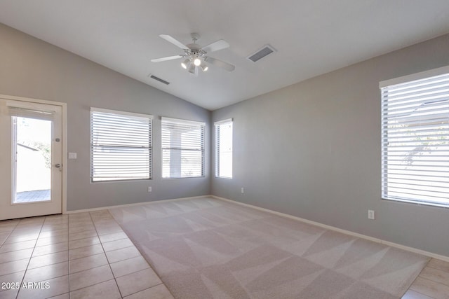 tiled empty room featuring ceiling fan and vaulted ceiling