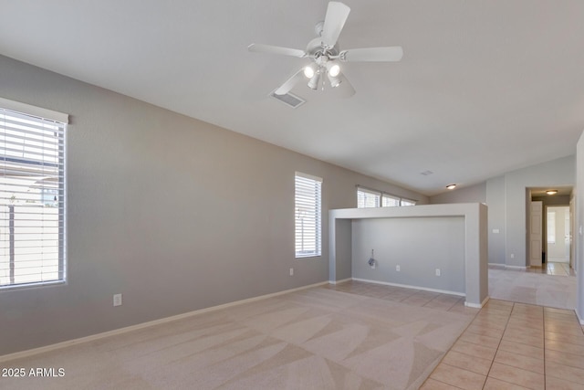 carpeted empty room with ceiling fan and lofted ceiling