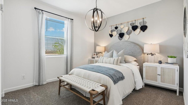 bedroom featuring dark colored carpet, baseboards, and an inviting chandelier