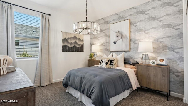 bedroom with wallpapered walls, baseboards, dark colored carpet, and a chandelier