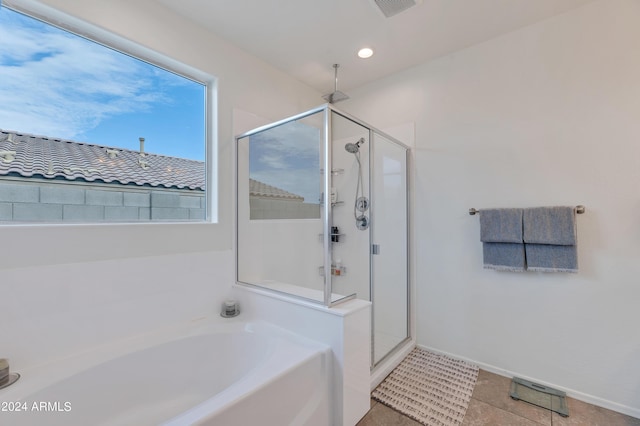 bathroom featuring shower with separate bathtub