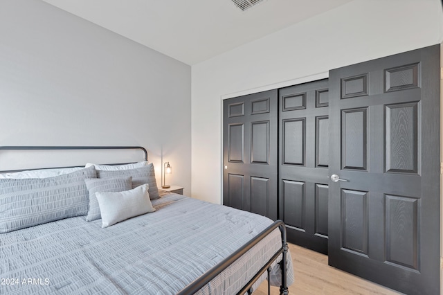 bedroom featuring light hardwood / wood-style floors and a closet