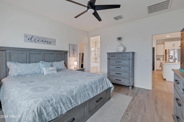 bedroom with ensuite bath, ceiling fan, fridge, stainless steel refrigerator with ice dispenser, and light wood-type flooring