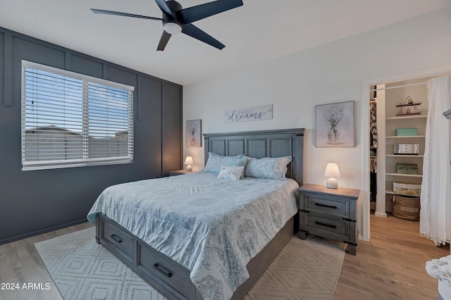 bedroom with light hardwood / wood-style floors and ceiling fan