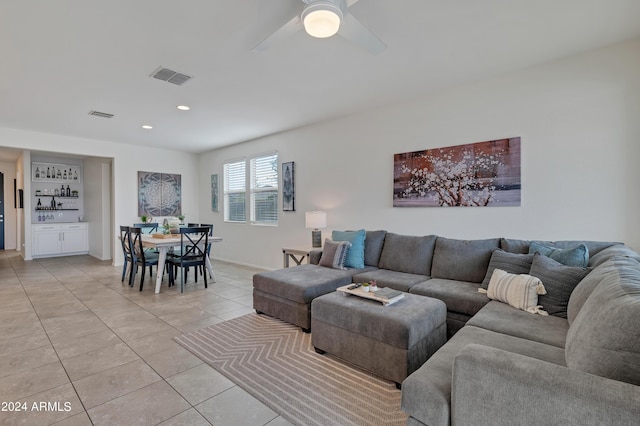 living room with ceiling fan and light tile patterned flooring