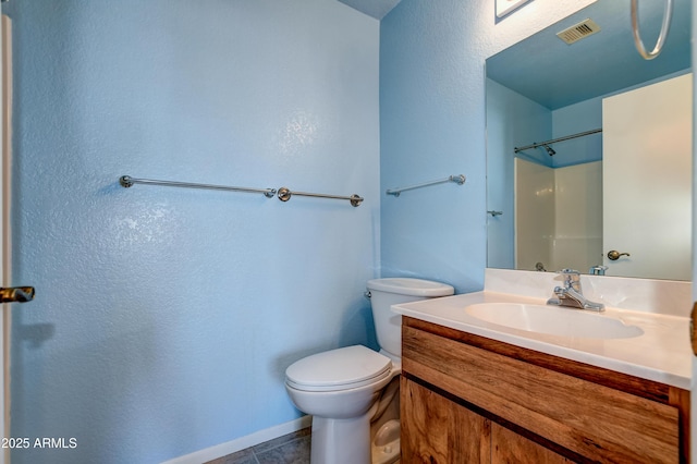 bathroom with a textured wall, vanity, toilet, tile patterned floors, and visible vents