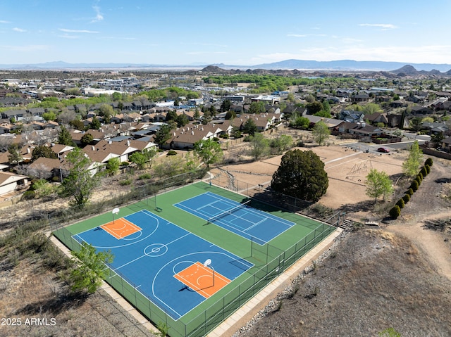 view of basketball court with a mountain view, community basketball court, and fence
