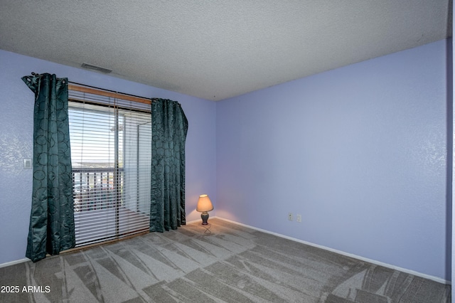 empty room with carpet floors, baseboards, and visible vents