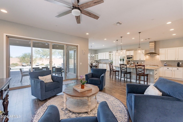 living room featuring ceiling fan and light hardwood / wood-style flooring