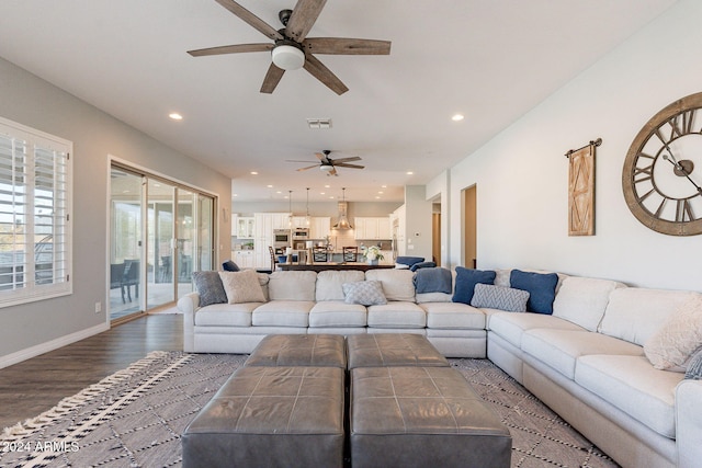 living room featuring ceiling fan and hardwood / wood-style flooring