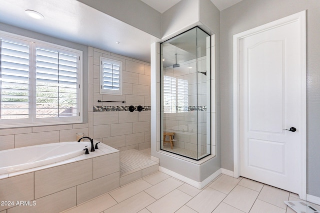 bathroom featuring tile patterned flooring and shower with separate bathtub