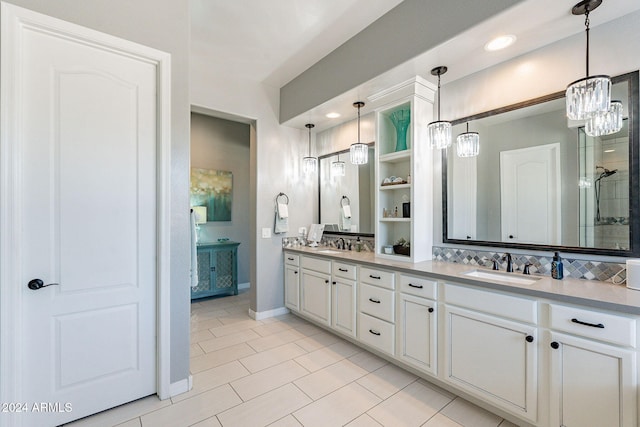 bathroom with decorative backsplash, vanity, a notable chandelier, and tile patterned flooring