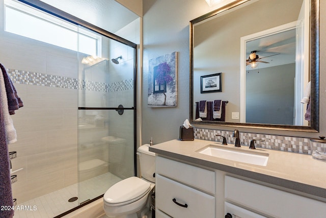 bathroom with ceiling fan, walk in shower, toilet, decorative backsplash, and vanity