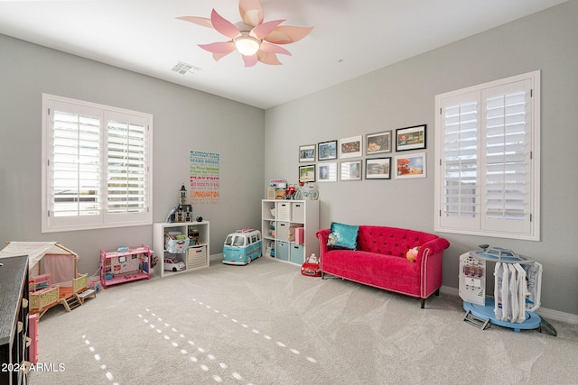 recreation room featuring carpet and ceiling fan