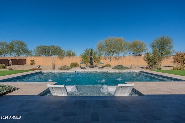 view of pool featuring pool water feature and a patio area