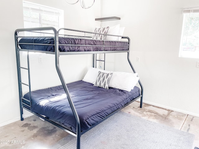 bedroom featuring concrete flooring