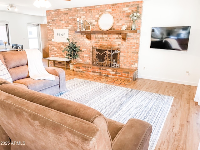 living room featuring a fireplace and light wood-type flooring