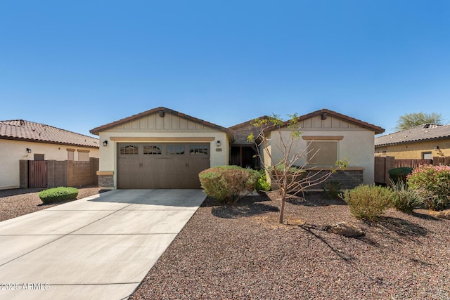 ranch-style home featuring concrete driveway, an attached garage, and fence