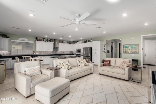 living room with visible vents, recessed lighting, and ceiling fan