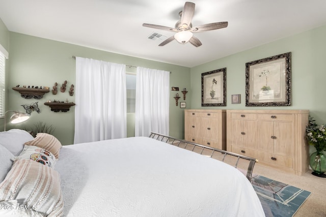 carpeted bedroom featuring visible vents and ceiling fan