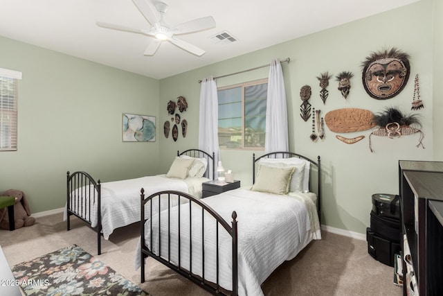 bedroom featuring multiple windows, baseboards, visible vents, and carpet floors