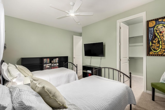 carpeted bedroom with a ceiling fan and baseboards