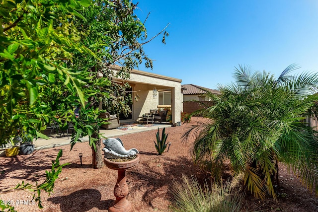 exterior space featuring a patio area, stucco siding, and fence