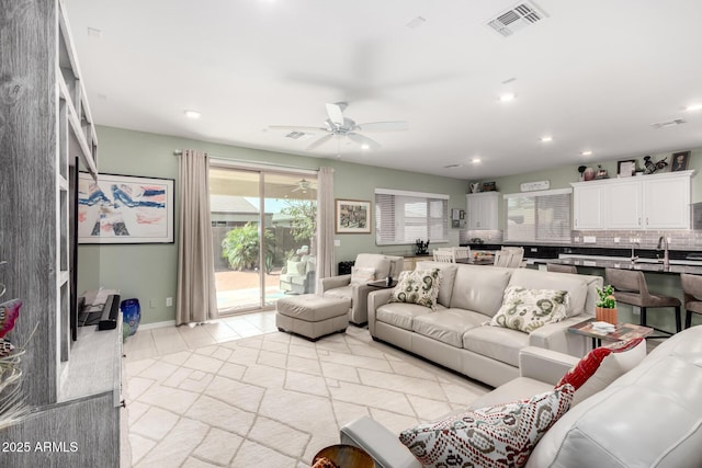 living room featuring light tile patterned floors, recessed lighting, visible vents, and ceiling fan