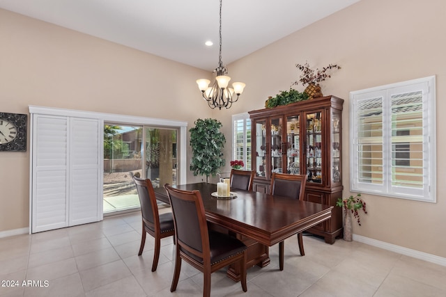 tiled dining space featuring a notable chandelier