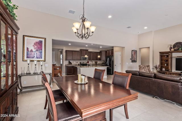 dining room featuring light tile patterned floors and an inviting chandelier