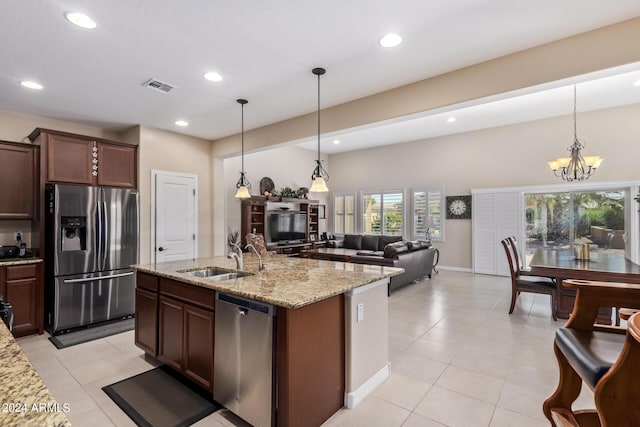 42915 W Kingfisher Dr, Maricopa, AZ 85138 - kitchen featuring hanging light fixtures, a sink, stainless steel appliances, light stone countertops, and visible vents